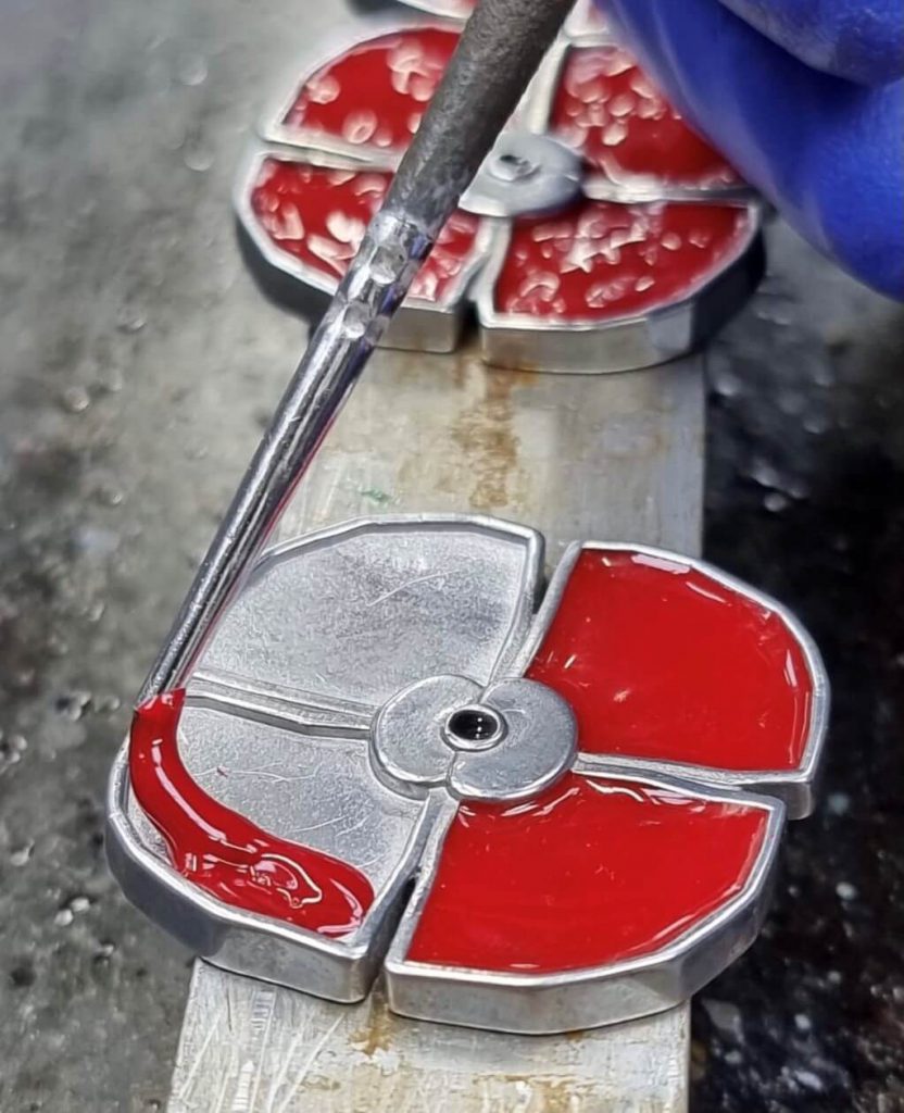 Metal poppy being filled with red enamel liquid 832x1024 - The story behind this year's RBL Masterpiece Poppy Coin