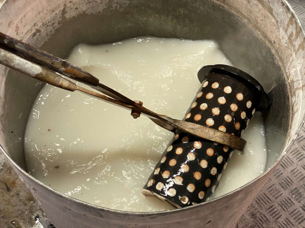 Poppy mould being put in liquid