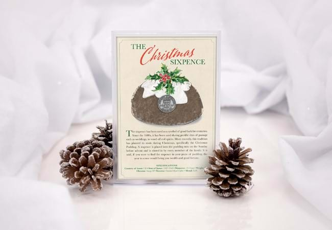 The Christmas Sixpence Frame presented on a white backdrop with snowy pine cones